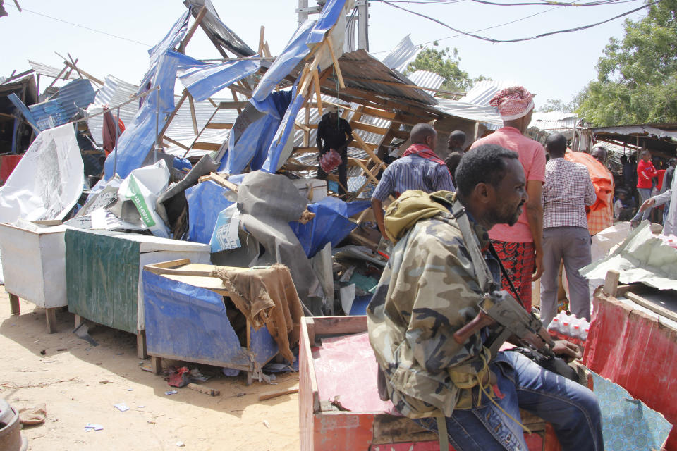 Somalis salvage goods after shops were destroyed in a car bomb in Mogadishu, Somalia, Saturday, Dec. 28, 2019. A truck bomb exploded at a busy security checkpoint in Somalia's capital Saturday morning, authorities said. It was one of the deadliest attacks in Mogadishu in recent memory. (AP Photo/Farah Abdi Warsame)