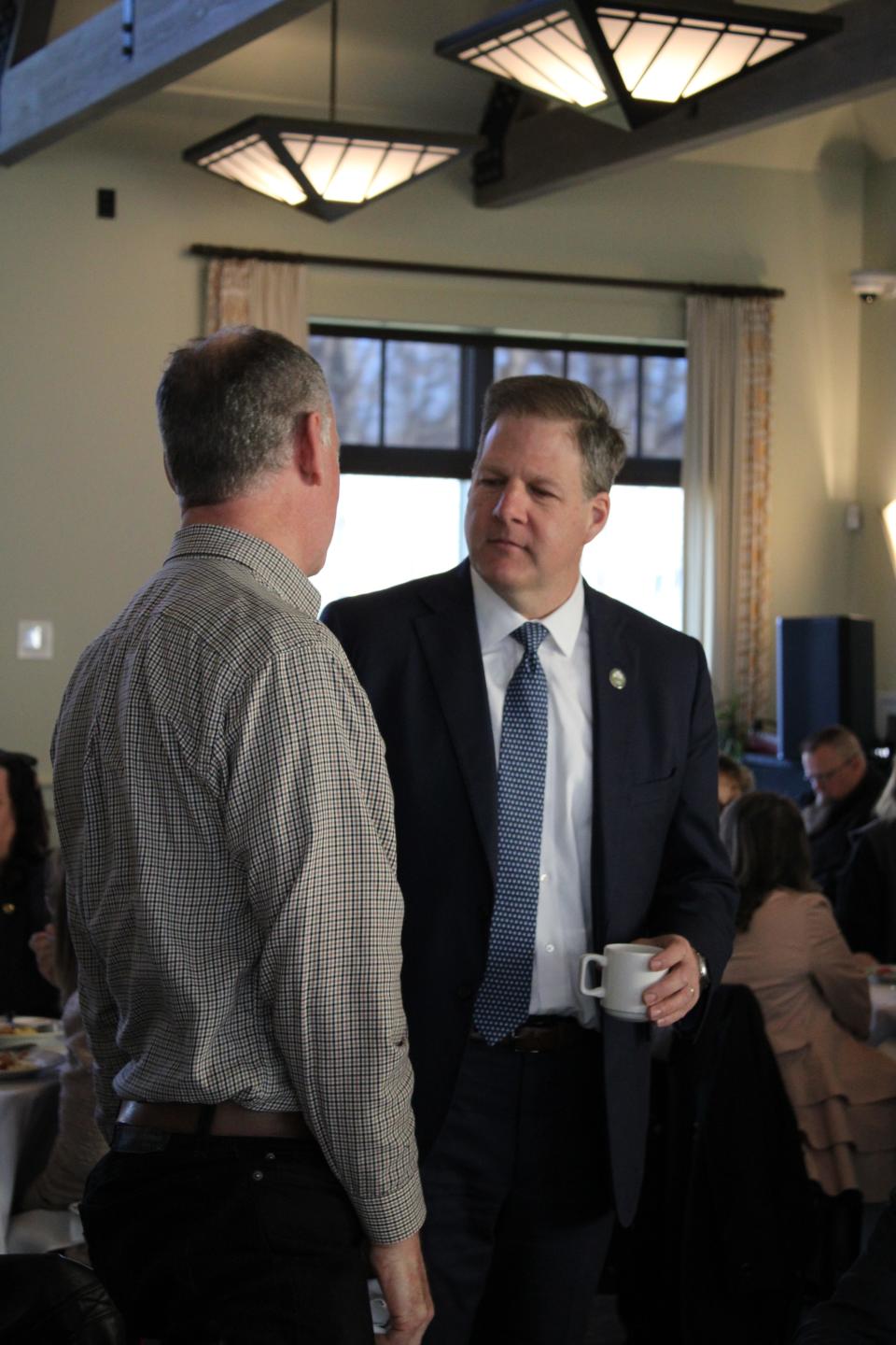 New Hampshire Gov. Chris Sununu talks with attendees at a State of the State 2024 event Tuesday, March 12 at Atlantic Grill in Rye.