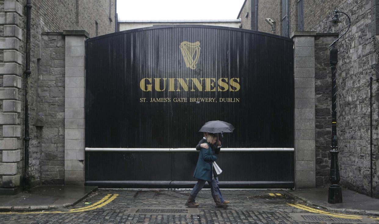 People walk past the Guinness Storehouse in Dublin (Niall Carson/PA)