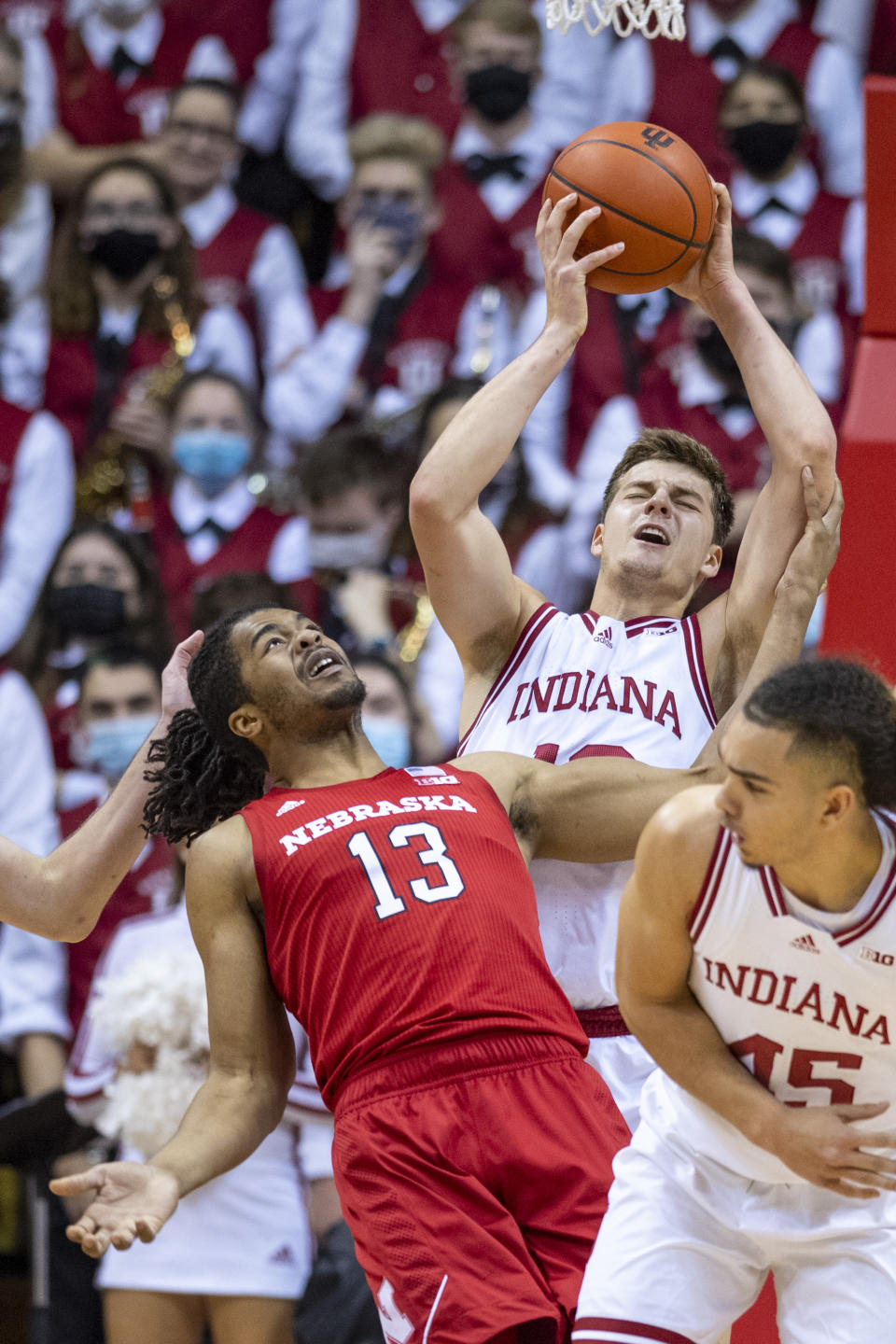 Nebraska forward Derrick Walker (13) and Indiana forward Miller Kopp (12) battle for a rebound during the second half of a NCAA college basketball game, Saturday, Dec. 4, 2021, in Bloomington, Ind. (AP Photo/Doug McSchooler)