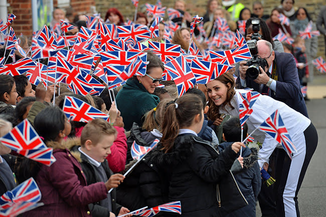 Kate Middleton hudled up with fans on the sidelines with mini Union Jack flags all around