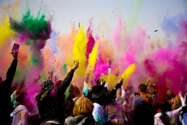 What is Holi, and why do people throw colored powder to celebrate?