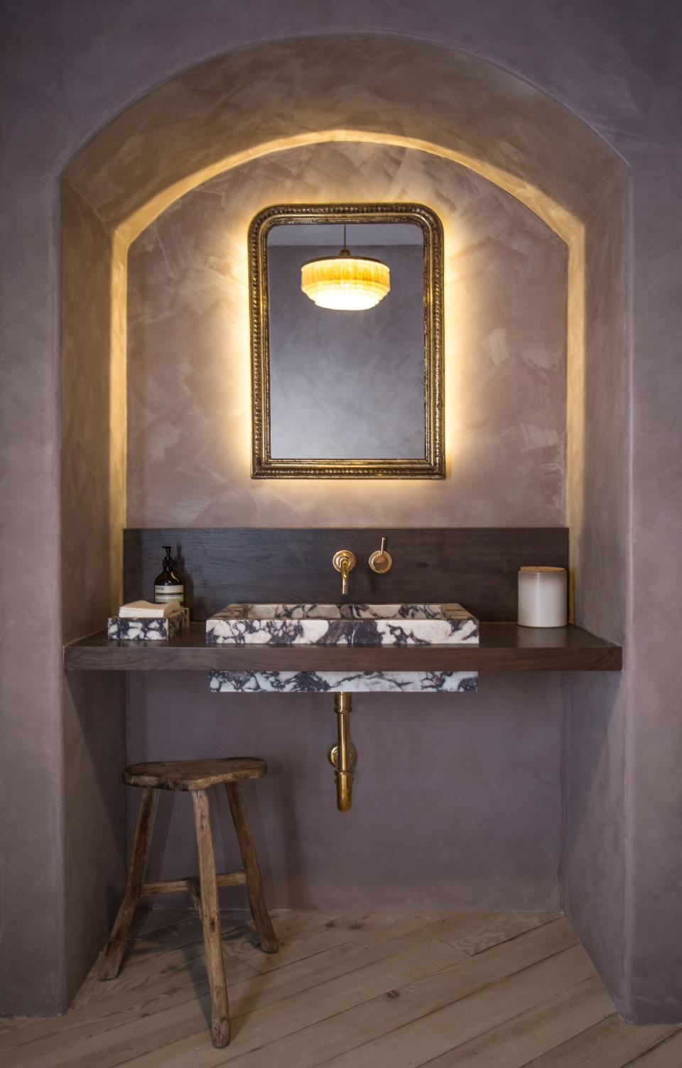 This vanity space is Jake’s favorite spot in the whole studio “because it shows that unexpected beauty can come from meeting restrictions of a commercial space.”