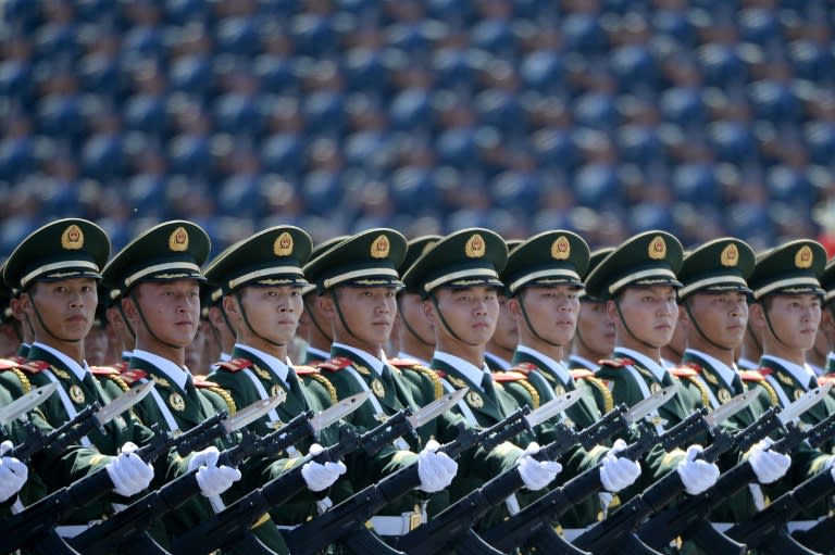 Chinese soldiers marching in formation during a 2015 parade at Tiananmen Square in Beijing