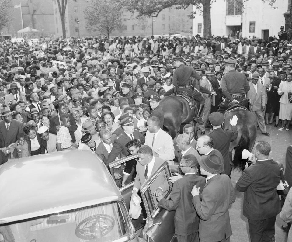 People in New York gather around Mamie Bradley, the mother of Emmett Till, to protest the acquittal of her son's murderers in Mississippi. (Photo: Bettmann/Getty Images)