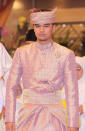 <div class="caption-credit"> Photo by: Wenn.com</div>The cost of clothing for such a series of events is enormous. Here, the groom, Pengiran Haji Muhammad Ruzaini, wears a formal outfit that Tiampo says "cost $10,000, off-the-cuff." The fabric, she says, appears to be pineapple fiber woven with golden thread. "The pineapple fibers are a bit sheer," she says, "and in warmer climates people want to wear something that's cool but formal. With the gold thread it would be in the hundreds of dollars a yard." <br>
