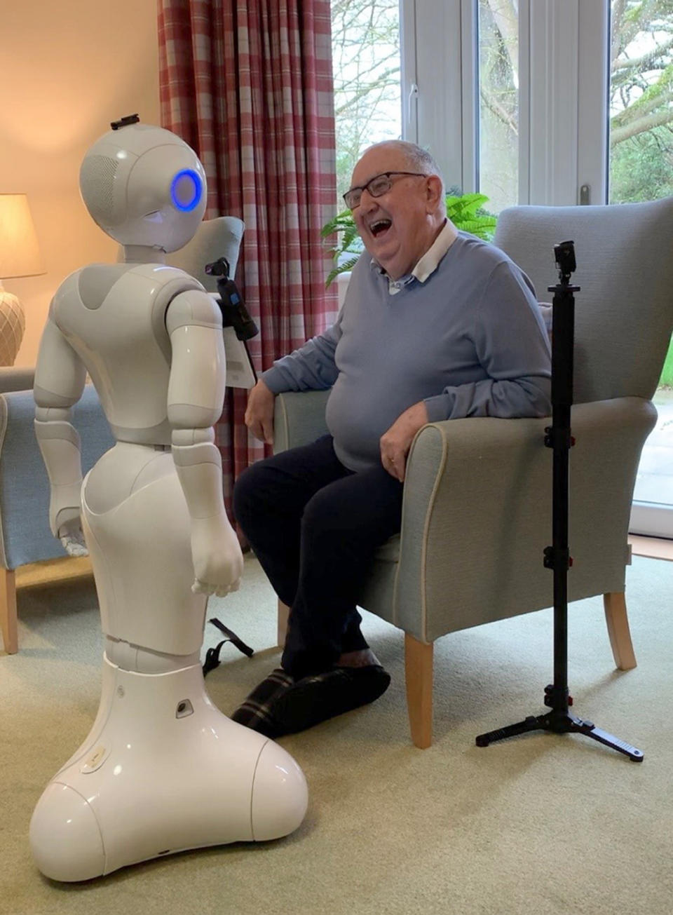 Pepper the robot with an elderly man (Photograph: PA)