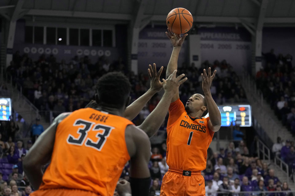 Oklahoma State's Bryce Thompson (1) takes a shot as Moussa Cisse (33) looks on in the first half of an NCAA college basketball game against TCU, Saturday, Feb. 18, 2023, in Fort Worth, Texas. (AP Photo/Tony Gutierrez)