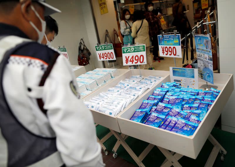 People wearing protective face masks queue to buy masks after the government announced state of emergency for the capital and some prefectures following the coronavirus disease outbreak in Tokyo