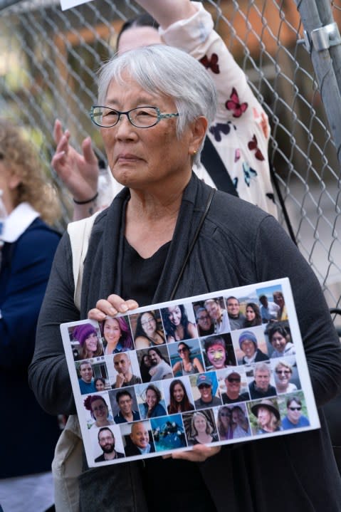 Barbara Chan who’s brother, Scott and niece, Kendra who were both killed in the Conception boat fire holds a composite photo of the victims in front of the U.S. Federal Building in downtown Los Angeles on Thursday, May 2, 2024. A federal judge on Thursday sentenced the scuba dive boat captain, Jerry Boylan to four years in prison and three years supervised release for criminal negligence after 34 people died in a fire aboard the vessel. (AP Photo/Richard Vogel)
