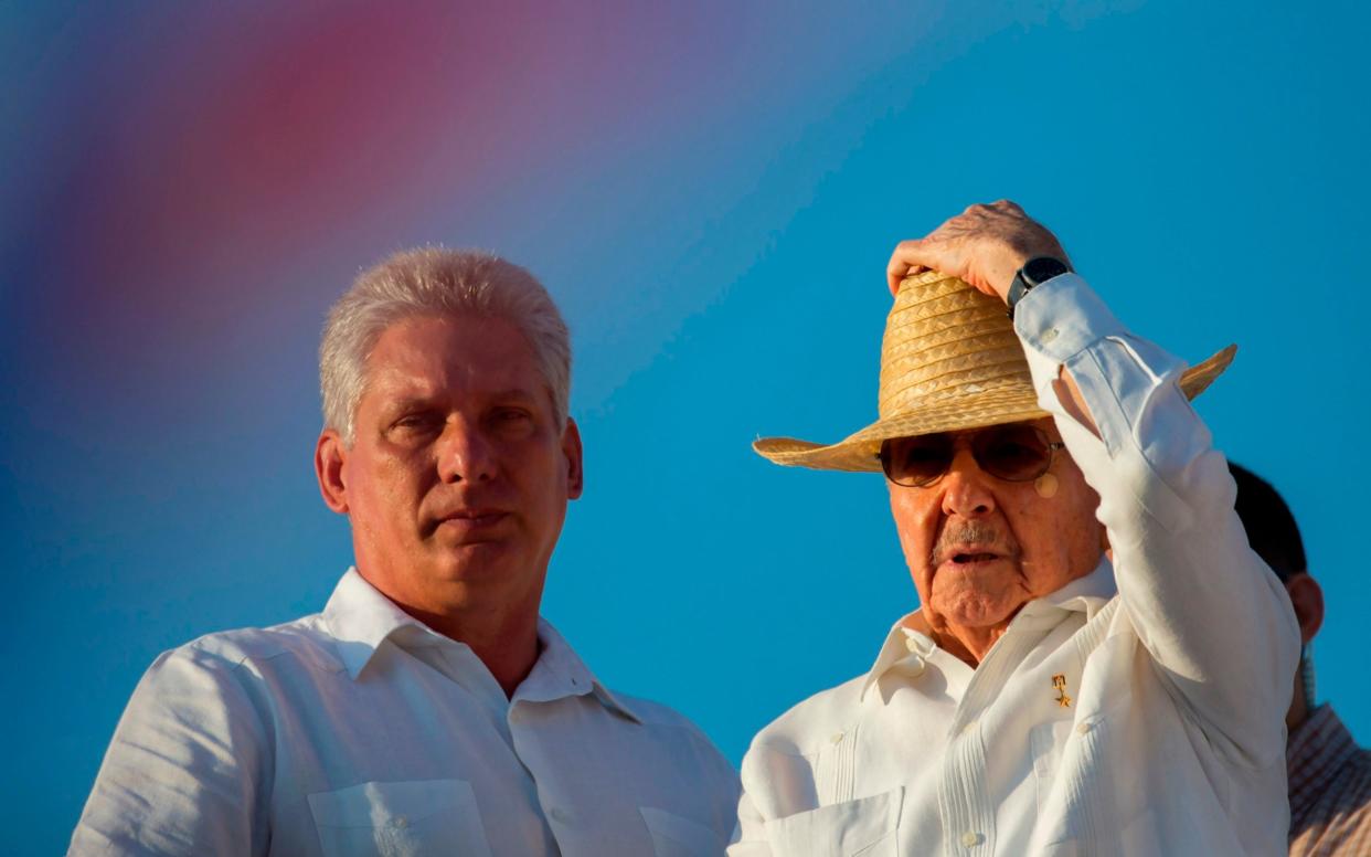 Cuba's First Vice President Miguel Diaz-Canel, left, stands with President Raul Castro during the May Day parade in Havana, May, 2016 - AP