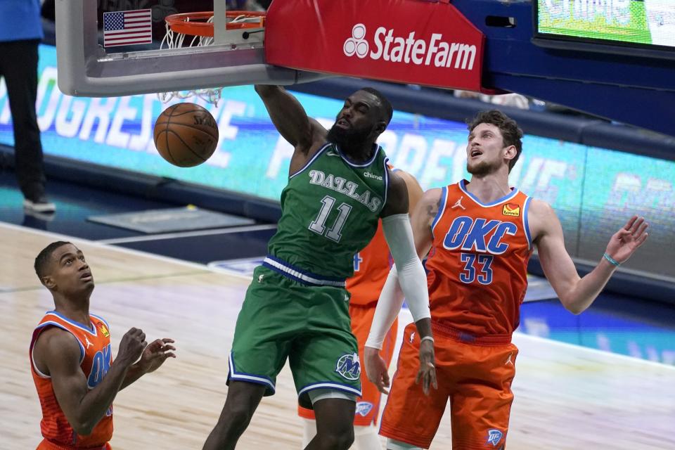 Oklahoma City Thunder's Theo Maledon, left, and Mike Muscala (33) look on as Dallas Mavericks forward Tim Hardaway Jr. (11) dunks the ball in the first half of an NBA basketball game in Dallas, Wednesday, March 3, 2021. (AP Photo/Tony Gutierrez)