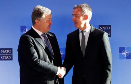 Ukrainian President Petro Poroshenko poses with NATO's Secretary General Jens Stoltenberg ahead of a meeting at the Alliance's headquarters in Brussels, Belgium December 13, 2018.  REUTERS/Francois Lenoir