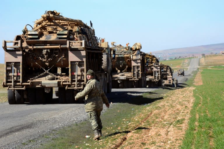 Turkish Army vehicles and tanks move near the Syrian border in Suruc on February 23, 2015