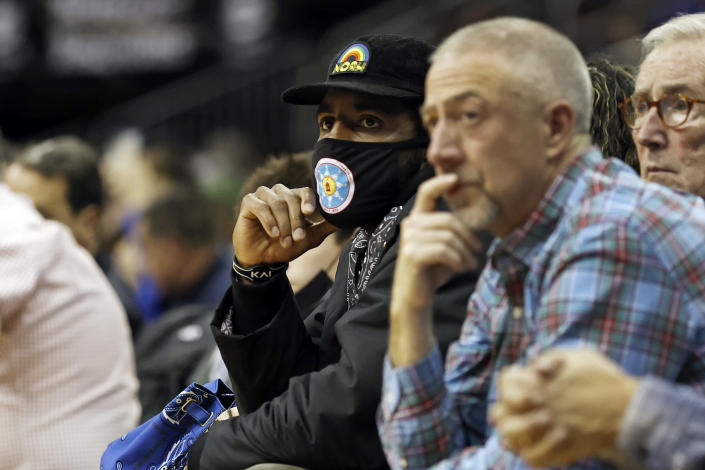 Brooklyn Nets' Kyrie Irving watches during the second half of an NCAA college basketball game between Wagner and Seton Hall on Wednesday, Dec. 1, 2021, in Newark, N.J. Seton Hall won 85-63. (AP Photo/Adam Hunger)