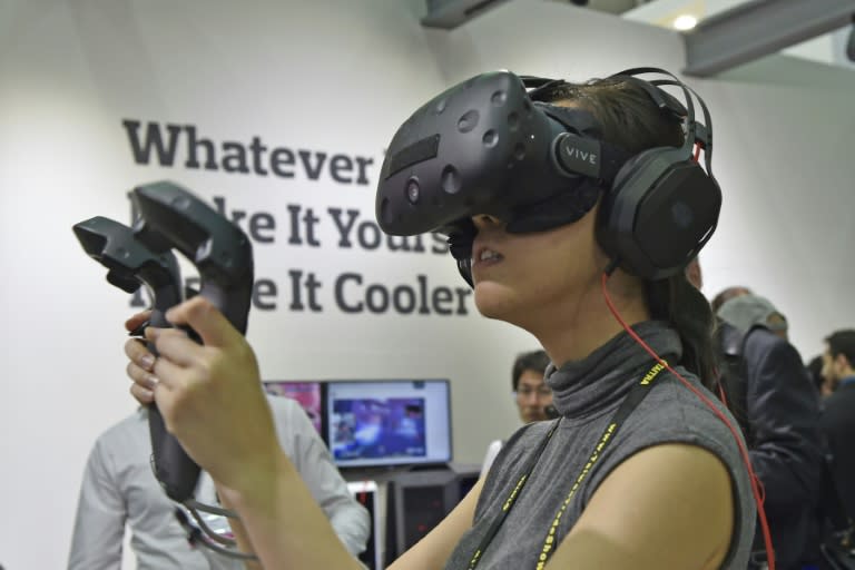 A visitor tests out the HTC Vive virtual reality (VR) headset during the annual Computex computer exhibition in Taipei on May 31, 2016