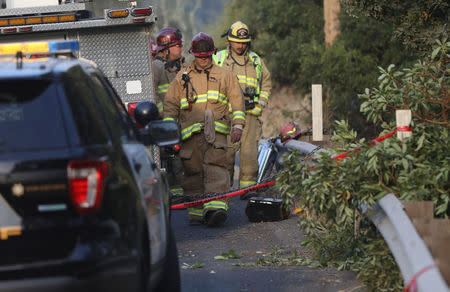 Firefighters work the scene of a fatal accident involving a water tender truck being used to fight wildfires in Oakville, California, U.S., October 16, 2017. REUTERS/Jim Urquhart