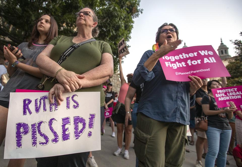 Abortion-rights supporters hold signs