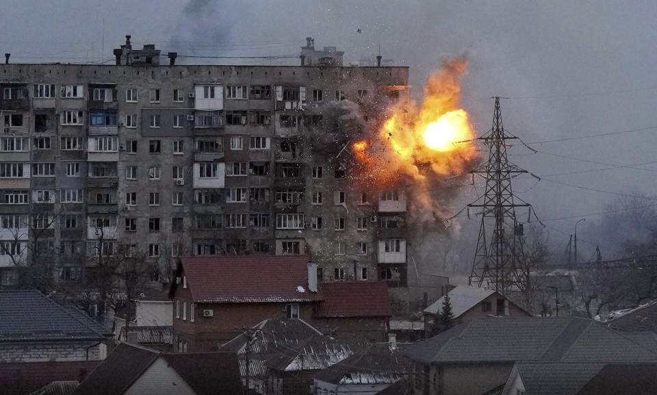 FILE - An explosion erupts from an apartment building after a Russian army tank fired on it in Mariupol, Ukraine, March 11, 2022. The image is part of the documentary "20 Days in Mariupol." (AP Photo/Evgeniy Maloletka, File)
