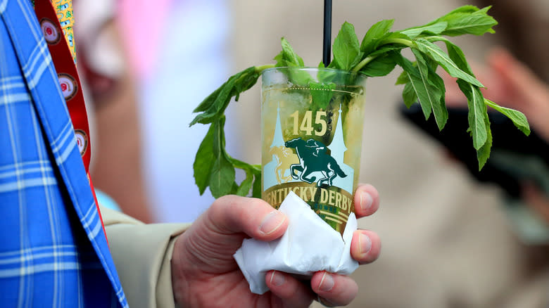 Person holding a mint julep cocktail at the Kentucky Derby