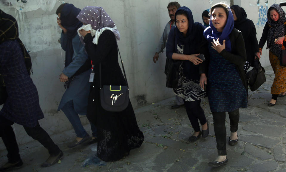 <p>Roshan mobile company employees leave the site of a suicide attack in Kabul, Afghanistan, Wednesday, May 31, 2017. (AP Photos/Massoud Hossaini) </p>