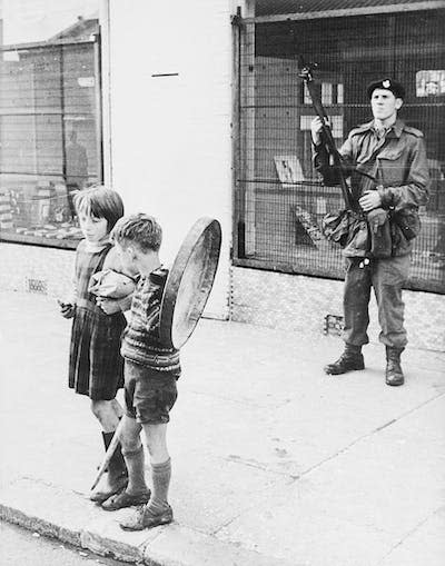 A soldier on patrol in Belfast in 1969. <a href="https://www.gettyimages.com/detail/news-photo/two-children-the-boy-with-rude-toy-weapons-stands-by-a-news-photo/514704064?adppopup=true" rel="nofollow noopener" target="_blank" data-ylk="slk:Bettmann/Getty Images;elm:context_link;itc:0;sec:content-canvas" class="link ">Bettmann/Getty Images</a>