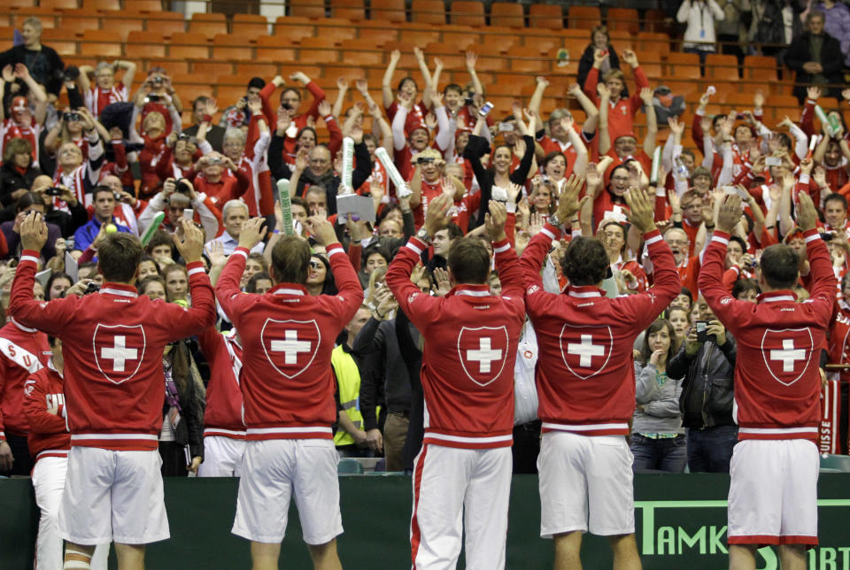 Switzerland's team, from left: Marco Chiudinelli, Michael Lammer, Stanislas Wawrinka, Roger Federer and captain Severin Luthi celebrate after winning their Davis Cup World Group play-off first round doubles tennis match against Nenad Zimonjic and Filip Krajinovic of Serbia, in Novi Sad, Serbia, Saturday, Feb. 1, 2014. Chiudinelli and Lammer won the match and gave Switzerland a 2-1 lead. (AP Photo/Darko Vojinovic)