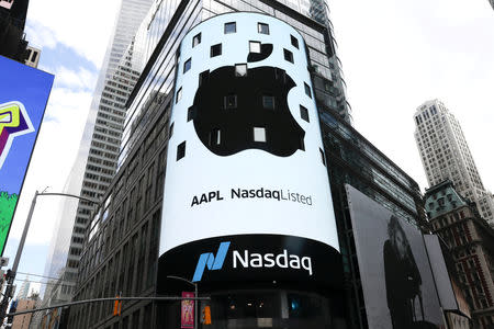 FILE PHOTO: An electronic screen displays the Apple Inc. logo on the exterior of the Nasdaq Market Site in New York City, New York, U.S., August 2, 2018. REUTERS/Mike Segar/File Photo