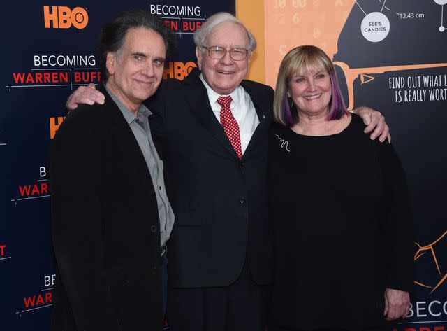 <p>Jamie McCarthy/Getty</p> From left: Peter, Warren and Susie Buffett in 2017