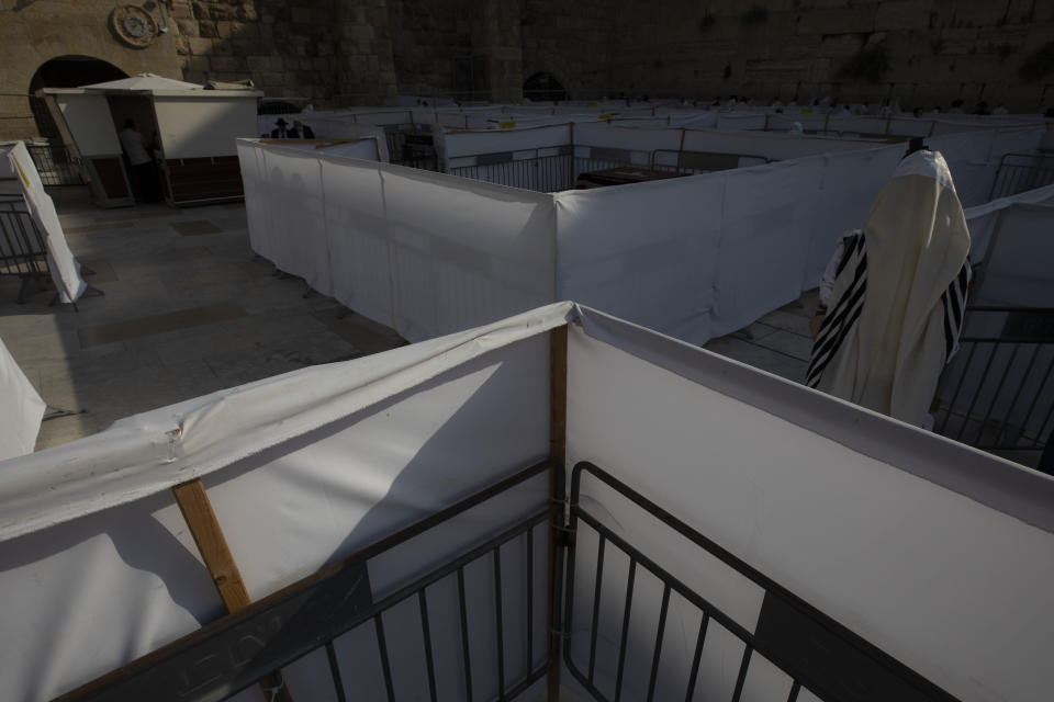 An ultra-Orthodox Jewish man prays ahead of the Jewish new year at the Western Wall, the holiest site where Jews can pray in Jerusalem's old city, Wednesday, Sept. 16, 2020. A raging coronavirus outbreak is casting a shadow over the normally festive Jewish New Year. With health officials recommending a nationwide lockdown, traditional family gatherings will be muted, synagogue prayers will be limited to small groups and roads will be empty. (AP Photo/Sebastian Scheiner)