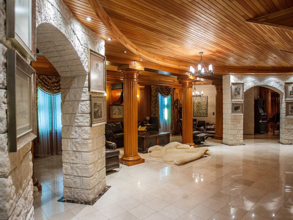 An interior shot of Medvedchuk's dacha featuring stone pillars and a fur rug.