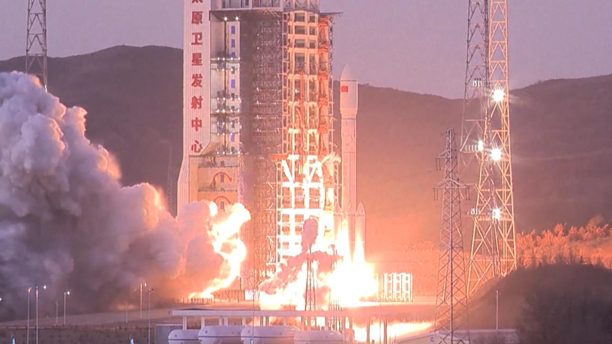  A rocket lifts off at sunset above a plume of fire. 