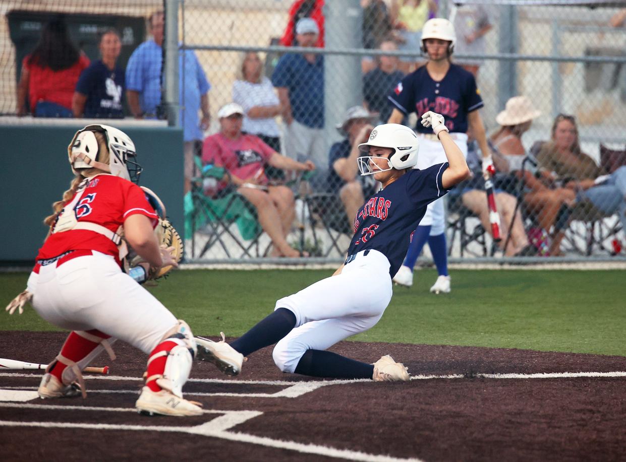 Lake Travis' Paige Connors tries to slide in safely at home for the South squad in the 2022 Austin Area All-Star Softball Game on Wednesday at Dripping Springs High School. In the annual meeting between the top seniors from the past season, the South squad beat the North 11-3.