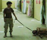 This is an image obtained by The Associated Press which shows Pfc. Lynndie England holding a leash attached to a detainee in late 2003 at the Abu Ghraib prison in Baghdad, Iraq. (AP Photo)