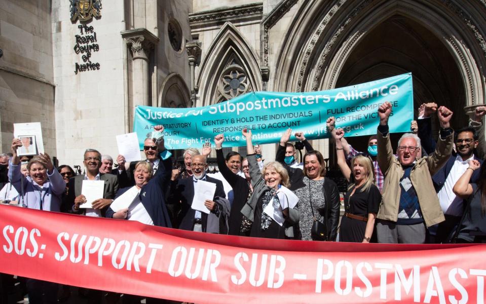 Postmasters celebrate outside the High Court after their convictions were quashed