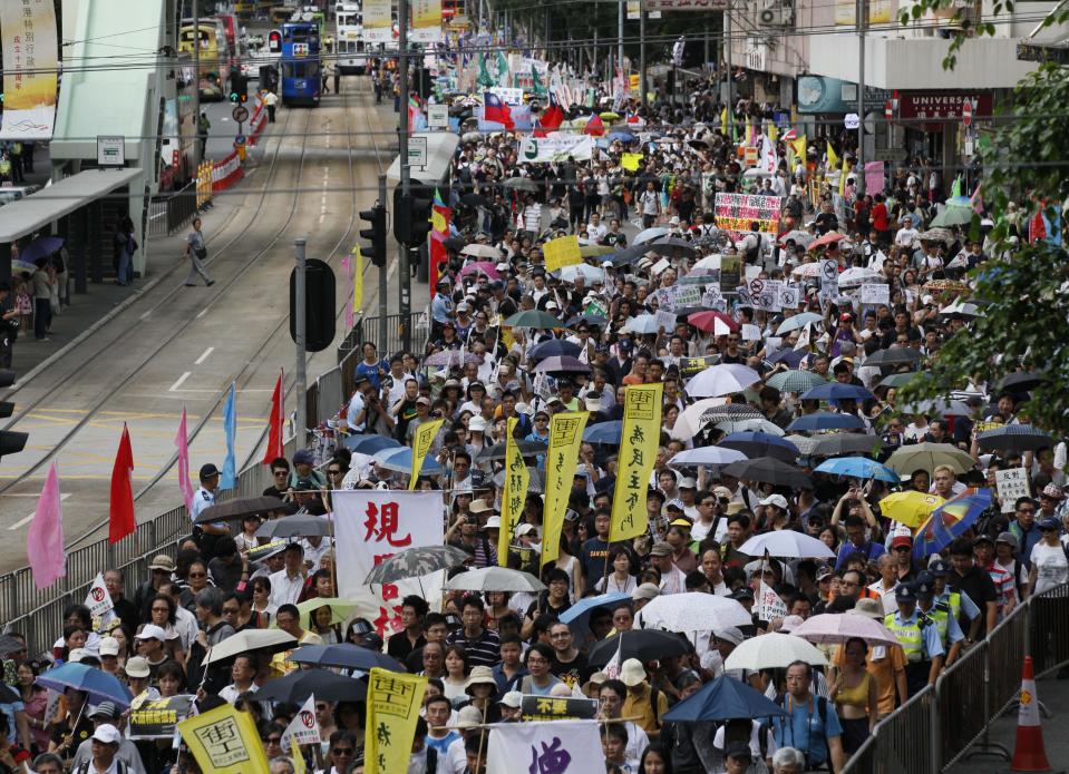 Tens of thousands of Hong Kong residents take part in an annual pro-democracy protest march in Hong Kong, Sunday, July 1, 2012. The march was an occasion for ordinary people to air their grievances over a range of issues. There is rising public discontent over widening inequality and lack of full democracy in the southern Chinese financial center. (AP Photo/Kin Cheung)
