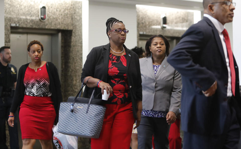 Allison Jean, center, the mother of Botham Jean arrives with family members for the murder trial of former Dallas police officer Amber Guyger in Dallas, Tuesday, Sept. 24, 2019. Guyger is on trial for shooting and killing Botham Jean, her unarmed neighbor, in the Dallas apartment building they both lived in. (AP Photo/LM Otero)