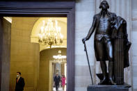 A statue of President George Washington is visible as House Speaker Nancy Pelosi of Calif., center right and Senate Minority Leader Sen. Chuck Schumer of N.Y., center left, step away from reporters after meeting with Treasury Secretary Steven Mnuchin and White House Chief of Staff Mark Meadows as they continue to negotiate a coronavirus relief package on Capitol Hill in Washington, Friday, Aug. 7, 2020. (AP Photo/Andrew Harnik)