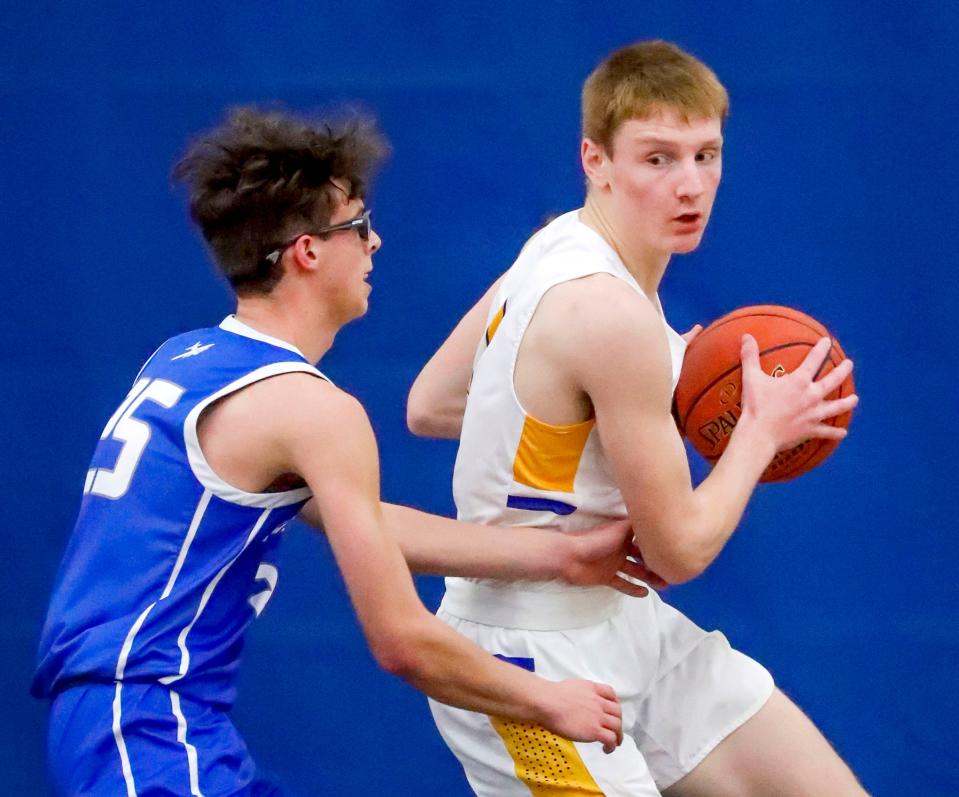 Howards Grove’s Trent Grunewald (1, right) eyes up Kohler’s Henry Pociask (25), Tuesday, January 24, 2023, in Howards Grove, Wis.