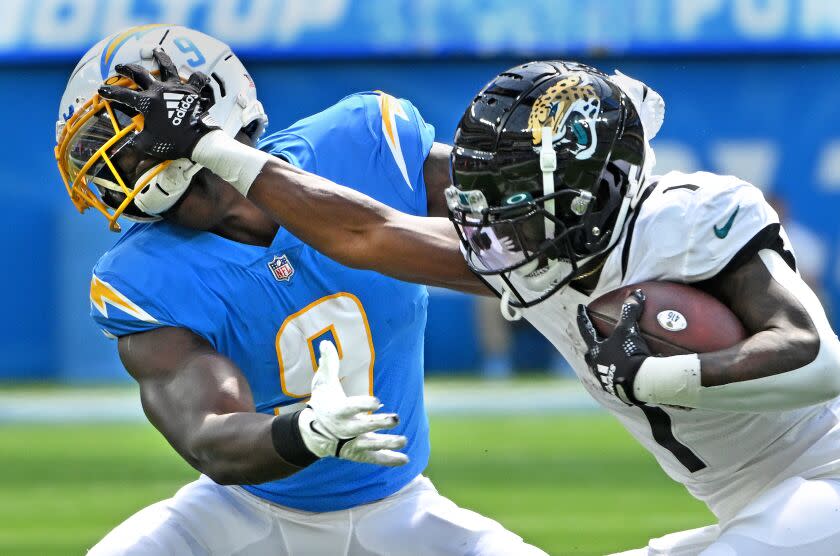 Inglewood, California September 25, 2022-Jaguars running back Travis Etienne stiff arms.