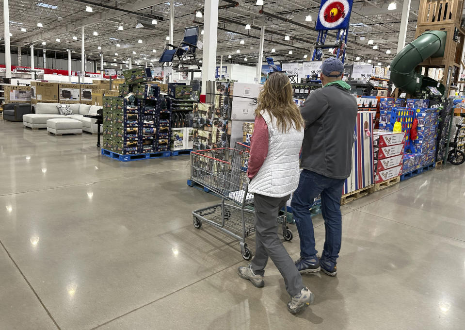 Shoppers pass displays of goods in a Costco warehouse Sunday, Feb. 25, 2024, in Sheridan, Colo. On Tuesday, March 26, 2024, the Conference Board issues its latest monthly report on U.S. consumer confidence, which captures public responses on issues ranging from purchasing plans to the direction of inflation. (AP Photo/David Zalubowski)