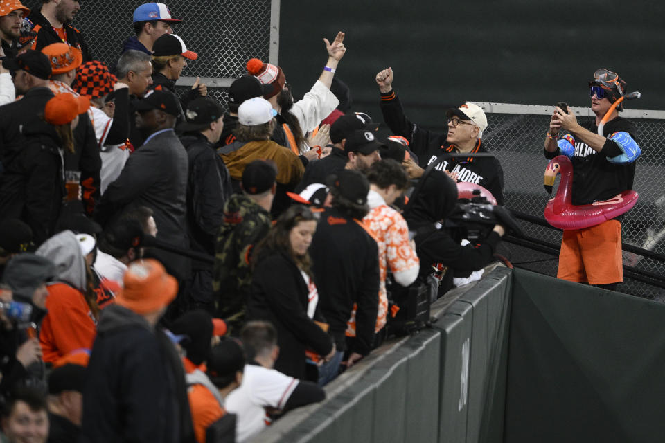 Baltimore Orioles owner David Rubenstein, second from right, stands next to 'Mr. Splash," right, during a baseball game between the Orioles and the Arizona Diamondbacks, Friday, May 10, 2024, in Baltimore. (AP Photo/Nick Wass)
