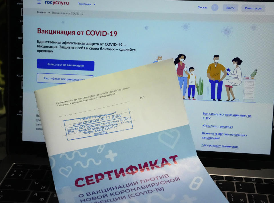 A vaccination certificate sits on a computer screen with the website Gosuslugi (public services portal) in Moscow, Russia, Monday, June 21, 2021. Police quickly cracked down, launching 24 criminal cases last week against sellers of fake vaccination certificates. Still, several accounts offering the bogus documents could be found easily on the Telegram messaging app this week. (AP Photo/Alexander Zemlianichenko)