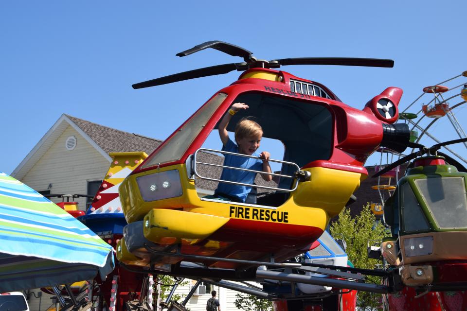 Ziggy Enriquez, 5, of Dallas, rides on a helicopter ride on Friday, July 21 at the 2023 Venetian Festival Carnival.