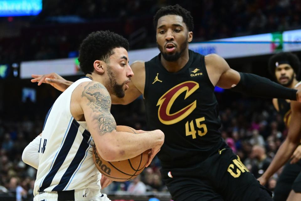 Memphis Grizzlies guard Scotty Pippen Jr. (1) drives to the basket against Cleveland Cavaliers guard Donovan Mitchell (45) on Wednesday in Cleveland.