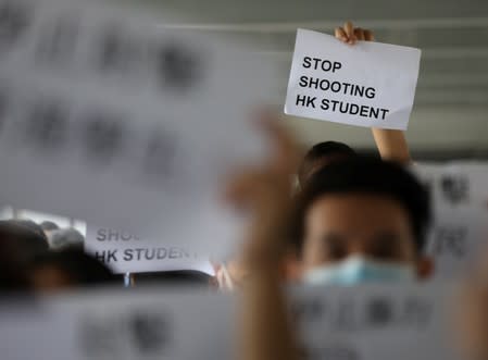 A protester holds a sign following a day of violence in Hong Kong