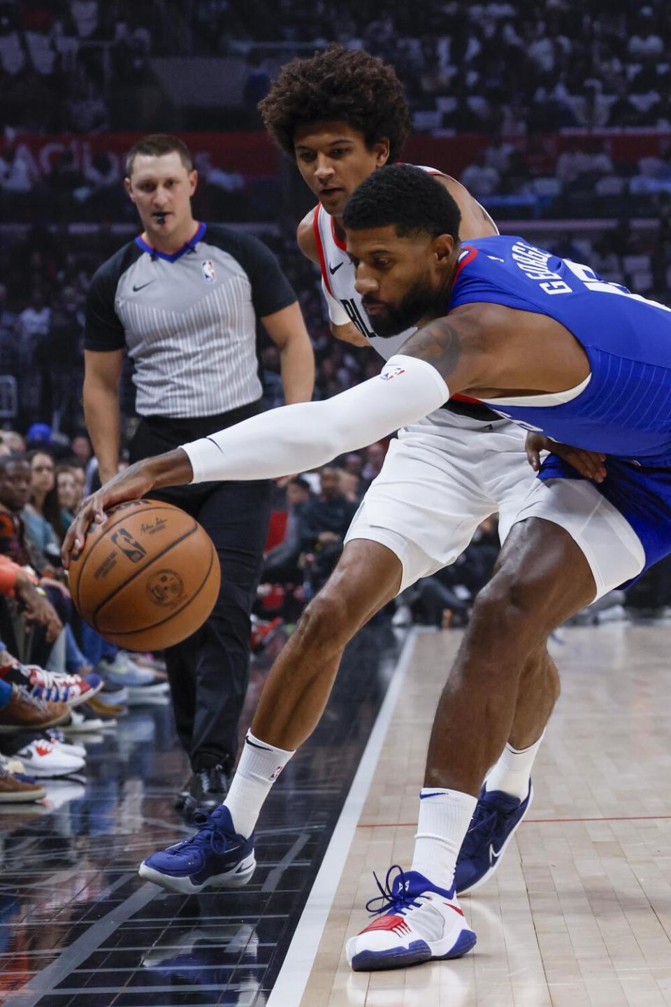 Clippers forward Paul George steals the ball from Trail Blazers guard Skylar Mays