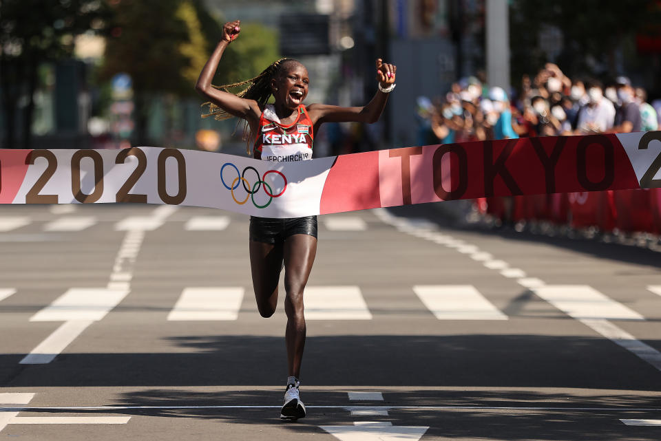 SAPPORO, JAPAN - AUGUST 07:  Peres Jepchirchir of Team Kenya celebrates as she crosses the finish line to win the gold medal in the Women's Marathon Final on day fifteen of the Tokyo 2020 Olympic Games at Sapporo Odori Park on August 7, 2021 in Sapporo, Japan.  (Photo by Clive Brunskill/Getty Images)