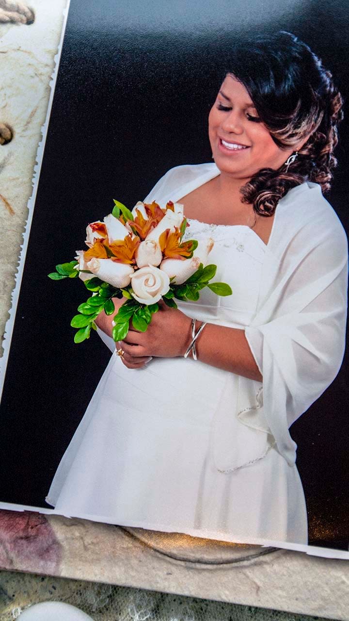 Leidy Figueroa is pictured wearing a wedding dress and holding flowers