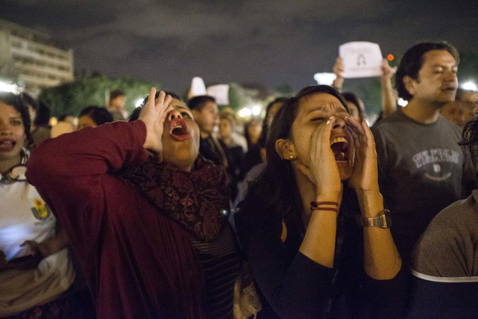 FILE - In this March 13, 2017 file photo, women chant slogans against Guatemala's President Jimmy Morales, who attends a Mass at the Metropolitan Cathedral, to demand justice for the 40 girls who perished in the fire at the Virgen de la Asuncion Safe Home, in Guatemala City. Officials arrested three former child welfare officials on suspicion of homicide, mistreatment of minors and failure to fulfill their duty in relation to the fire. (AP Photo/Moises Castillo, File)